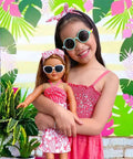 18 inch doll in Travel outfit shown with child wearing accessory